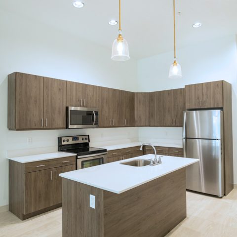 Kitchen in Downtown Wilmington, DE apartments with wooden cabinets and stainless steel appliances 