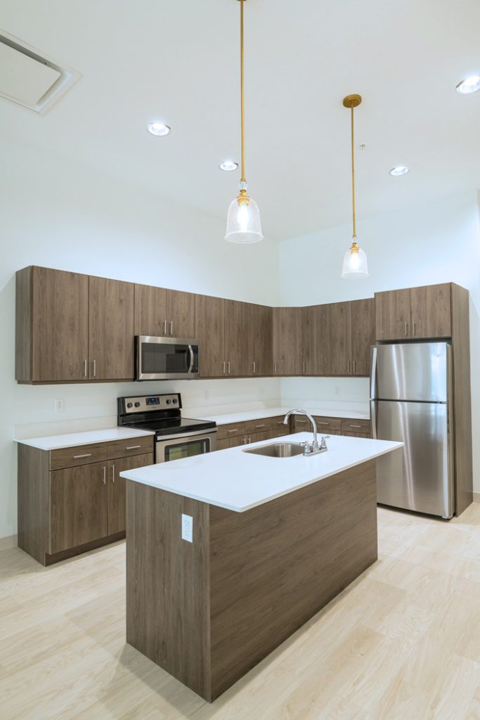 Kitchen in Downtown Wilmington, DE apartments with wooden cabinets and stainless steel appliances 