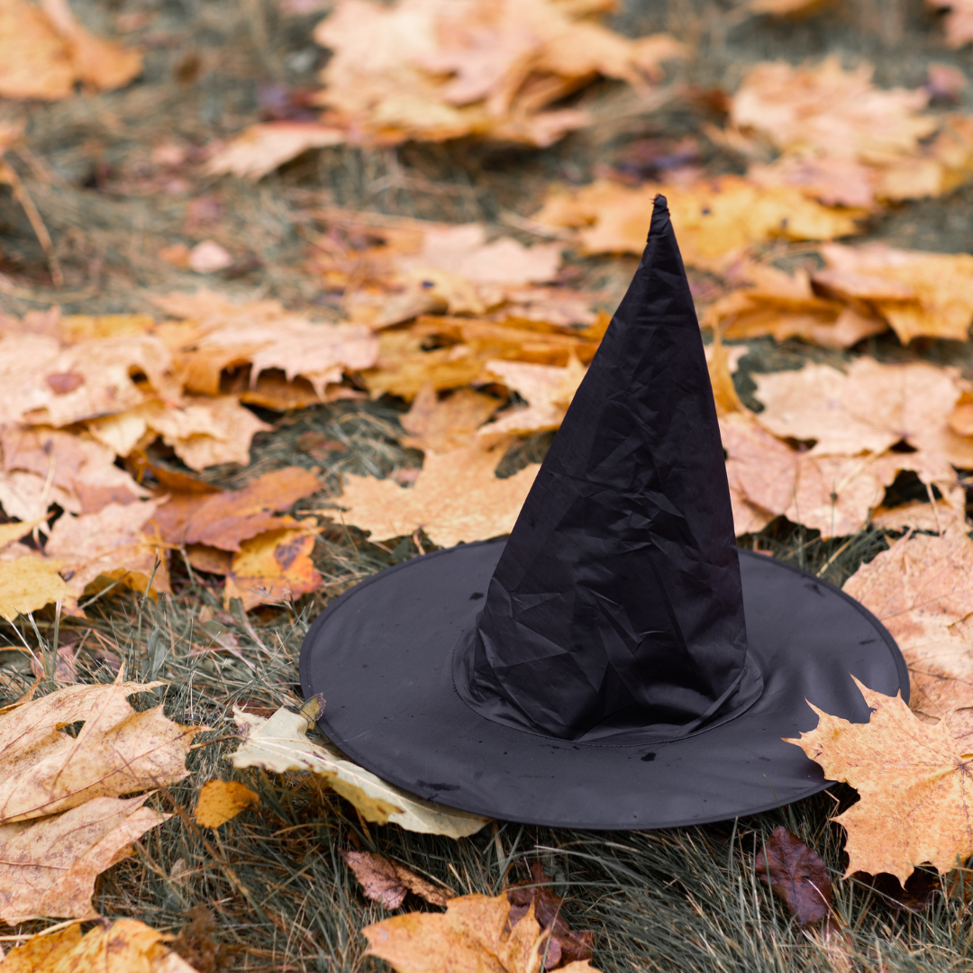 Halloween witch hat on ground surrounded by leaves, for Halloween events in Wilmington Delaware